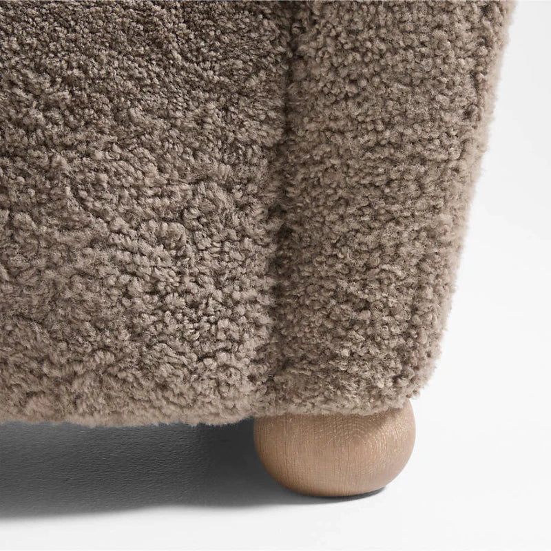 Close-up of a textured brown fabric surface with a neutral background