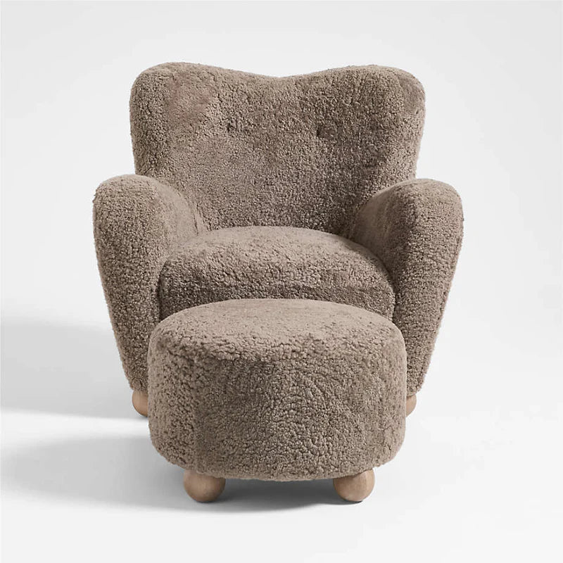 Brown boucle armchair with matching ottoman on a white background