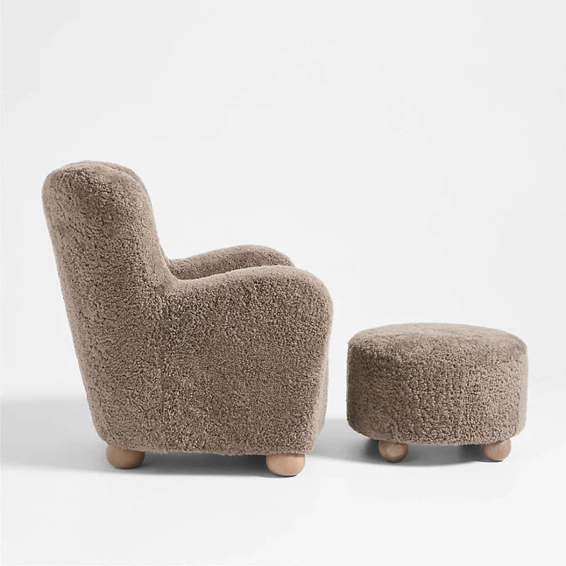 Brown plush armchair and ottoman on a white background